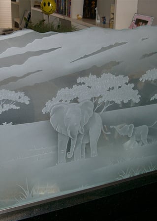 Partition showcasing a Frosted Glass Wildlife Design with Sandblast Etched Glass Art by Sans Soucie Elephants in the Wild Design