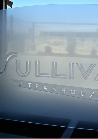 Partition with Frosted Glass Logos Sullivans Steakhouse (similar look) Design by Sans Soucie