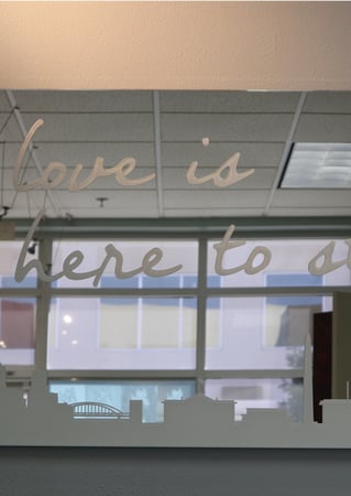 Glass Wall Art featuring a Frosted Glass Sayings Design Sandblast Etched Glass Here to Stay Design by Sans Soucie