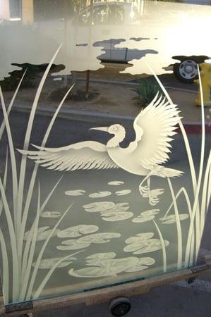 Window showcasing a Frosted Glass Wildlife Design with Sandblast Etched Glass Art by Sans Soucie Dancing Egret Design