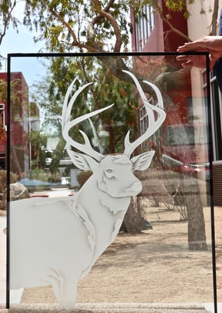 Window showcasing a Frosted Glass Wildlife Design with Sandblast Etched Glass Art by Sans Soucie Deer in View Design