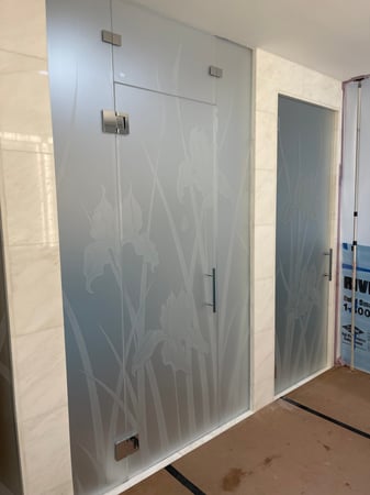 Shower Enclosure featuring a Frosted Glass Floral Design Sandblast Etched Glass Iris Hummingbird Design by Sans Soucie
