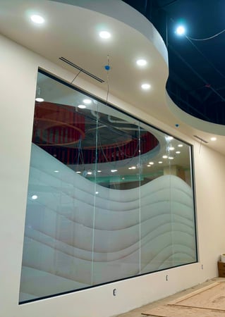 Partition showcasing a Frosted Glass Abstract Design with Sandblast Etched Glass Art by Sans Soucie Dreamy Waves Design