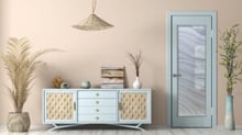 Light blue frosted glass interior door with hand-etched wavy design, 100% private 2D sandblast effect, shown in a modern coastal-style room with beige walls and decorative vase with yellow flowers
