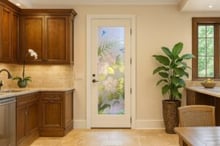 Traditional kitchen interior featuring a decorative glass for pantry doors with a vibrant frosted floral design and painted hummingbirds.