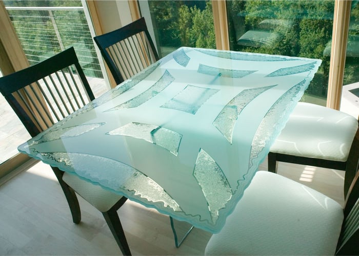 custom glass dining table with frosted carved glass geometric design irregular edge