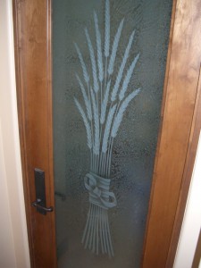 "Bundled Wheat" pantry door etched glass.  The wheat and bow are multi-stage sculpture carved, the background is gluechipped for obscurity.