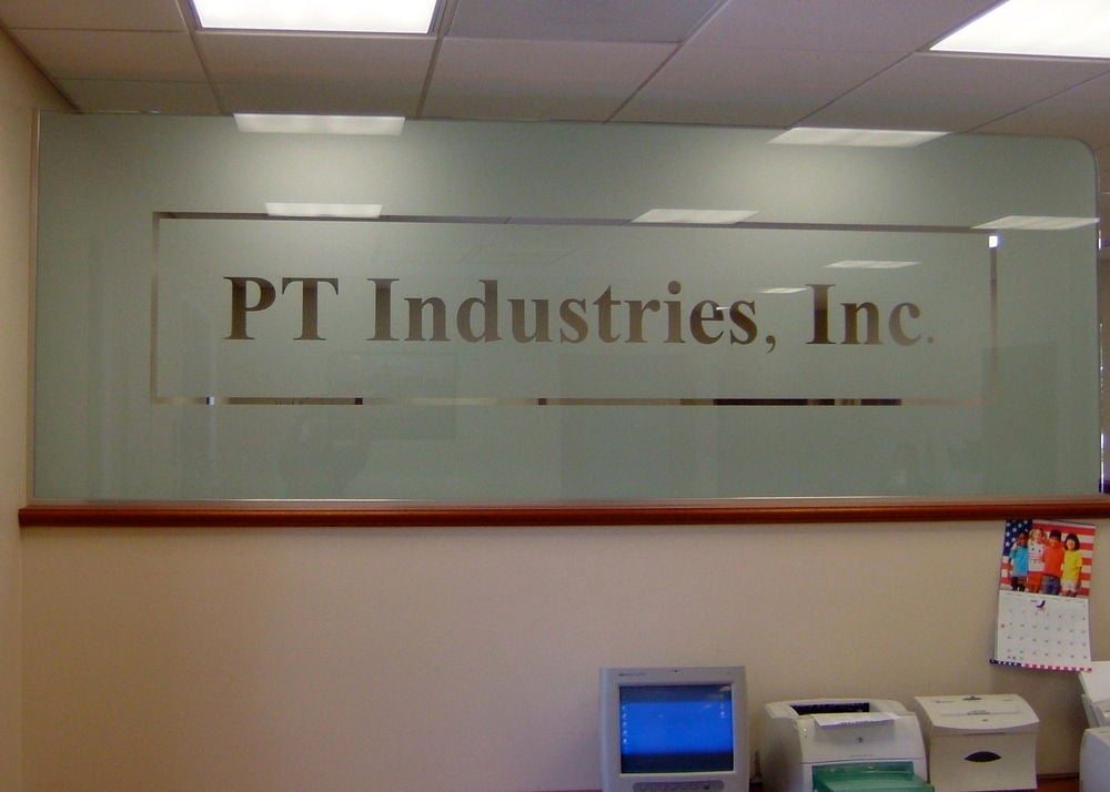 Glass Partition etched, frosted glass logo / lettering in clear glass.