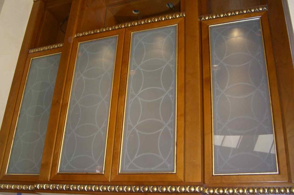Etched, decorative glass cabinet inserts, with a gorgeous contemporary overlapping circles design.  Design is carved and the background has been etched or frosted solid for complete obscurity.