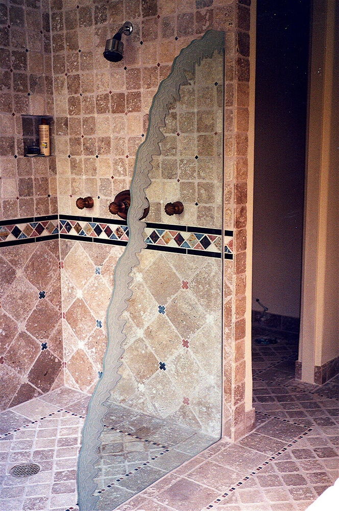 Freestanding glass shower divider panel, etched carved "Shoreline Waves" custom edge.