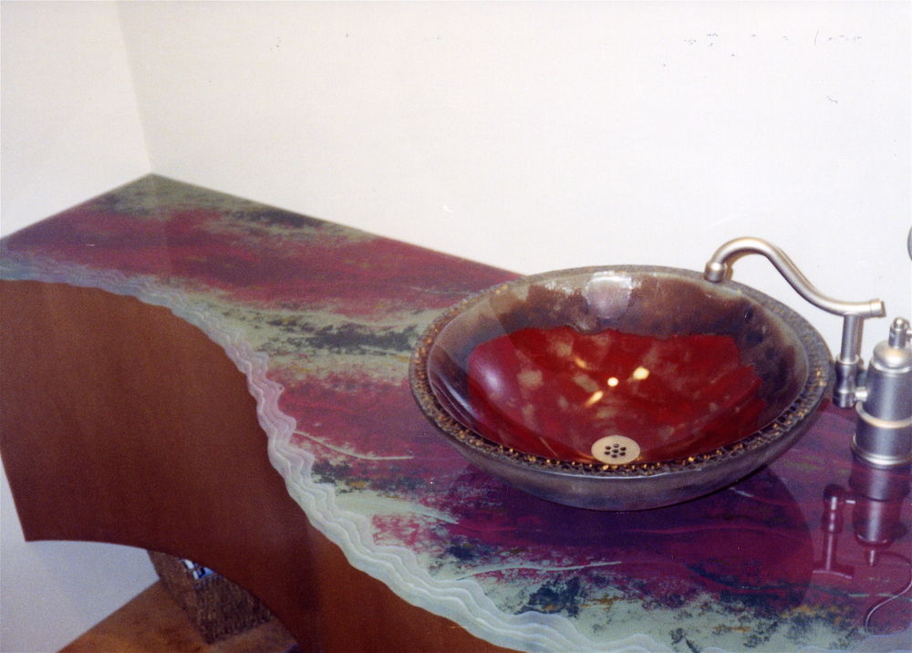 Decorative glass bath vanity top.  Etched, carved and painted glass with a Shoreline Edge on the top surface.