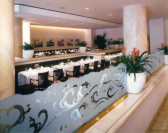 Etched Glass Panels, restaurant dividers that have been solid (reverse) etched, with an irregular chiseled top edge.  This glass is installed inside the Long Beach Renaissance Hotel, in Long Beach,  California.