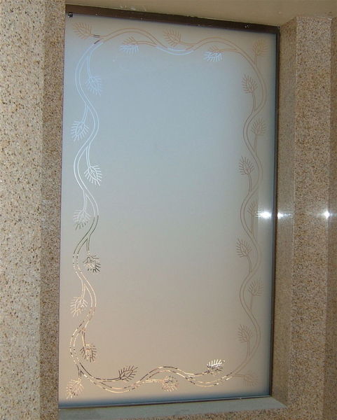 An Etched Glass Window, with an Acorn Border design in clear glass.  A classic example of a "reverse or negative sandblast".