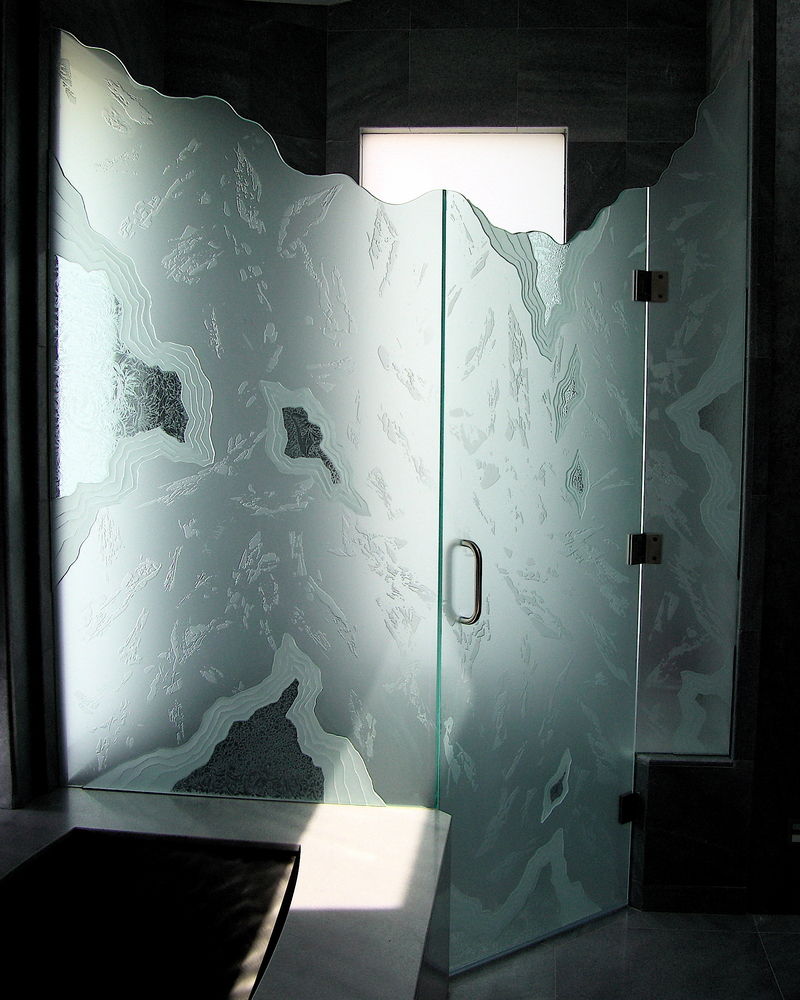 Frameless Glass Shower, etched carved glass overlay pieces and chiseled irregular top edges.