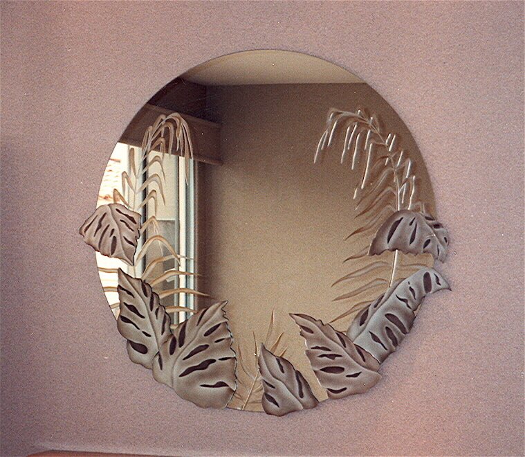 Decorative round mirror with etched, carved & painted glass overlay pieces. Fern leaves are etched and carved on the front surface.