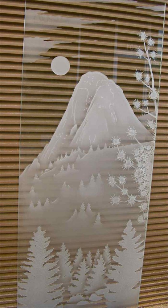 A view of Idyllwild, California's beautiful "Tahquitz Creek" etched and dimensionally sculpture carved in a front entry door glass panel for Idyllwild residence.