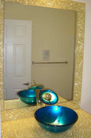 Glass Bathroom Vanity, features clear shattered glass and gold mirror.  Sink is a brilliant blue with gold accendint.