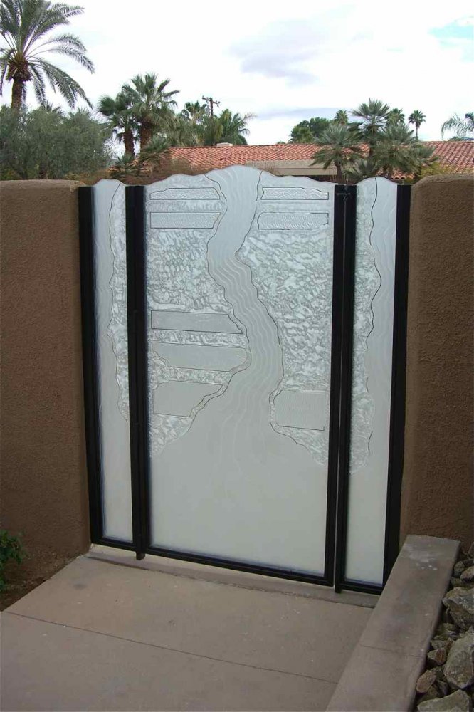 "Triptic" Gate Glass.  This glass is exposed on the top edges, and we've added custom chiseled iregular edging.  There are narrow sidelite panels wth a center door glass.