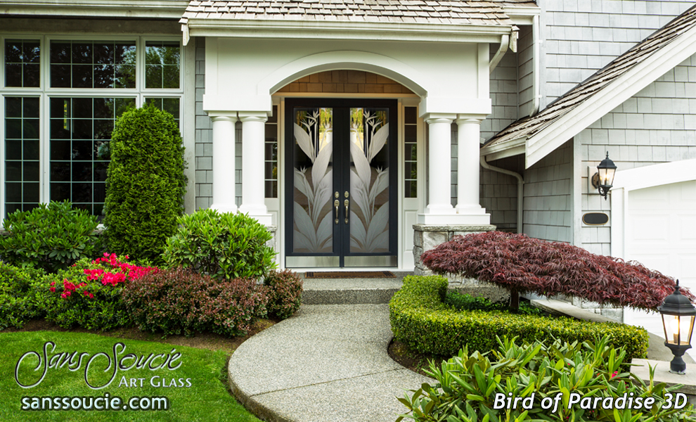 Transitional double wood front doors with symmetrical frosted glass panels featuring mirrored bird-of-paradise leaves.