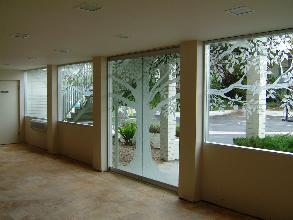 Expert installation of large-scale frameless glass panels with tree design for long-term performance