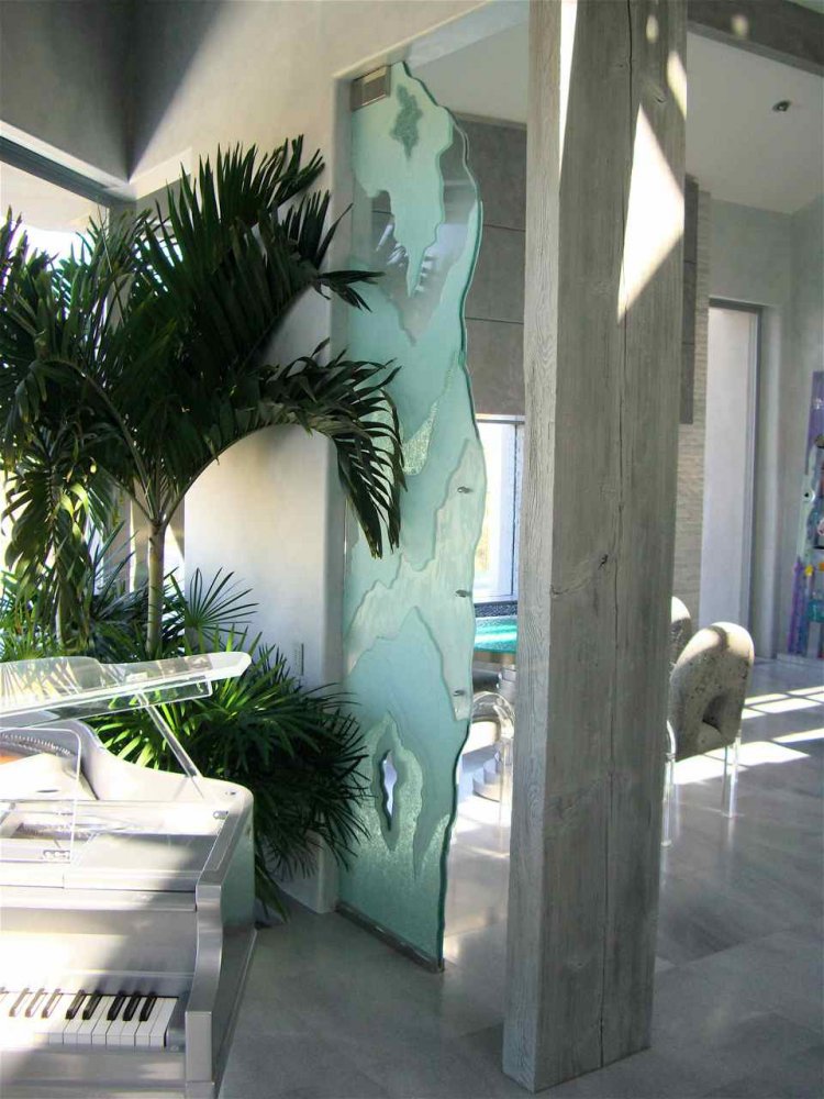 glacial textured carved glass panel with organic edge design used as decorative interior partition