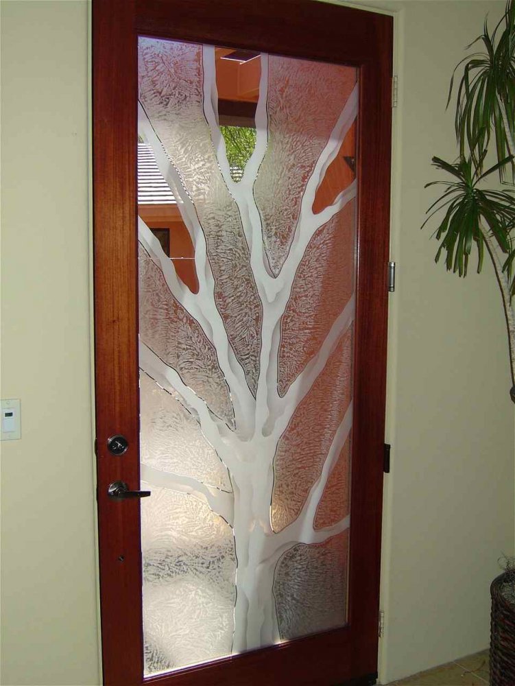 Frosted glass front door with tree design featuring carved barren branches and textured gluechip background
