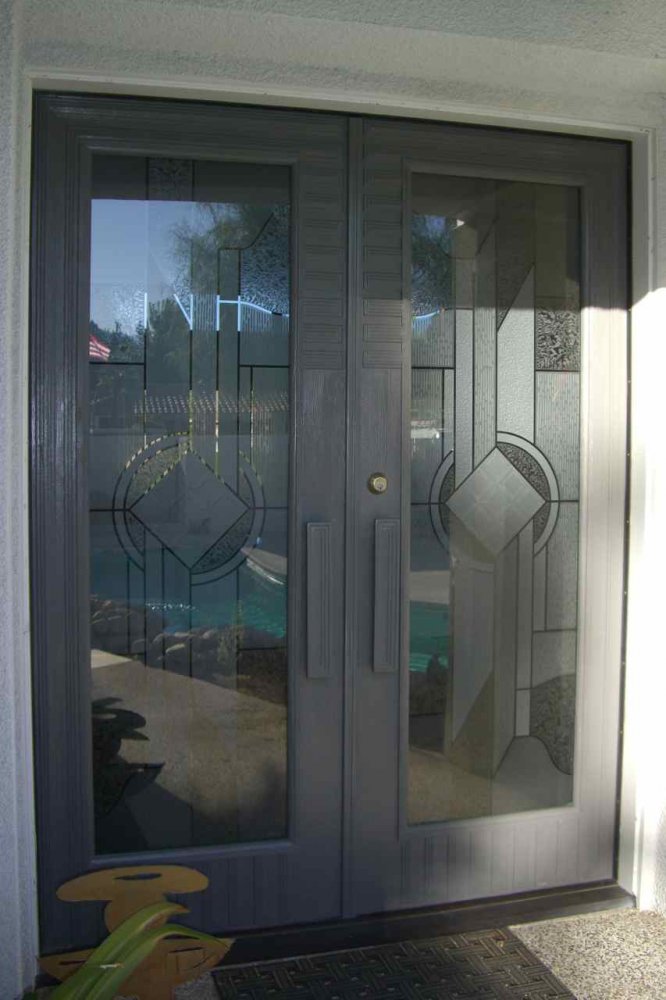 Double front doors with 2026 trending carved and frosted glass design