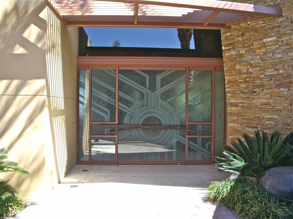 Decorative all exterior glass door with custom decorative etched glass design