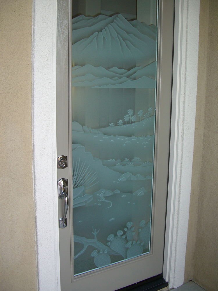 Frosted glass door with carved desert landscape and cactus scene