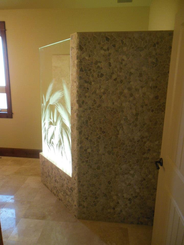 Illuminated wheat glass partition wall integrated into a bathroom shower enclosure, showcasing custom frosted glass with elegant wheat motif artwork.