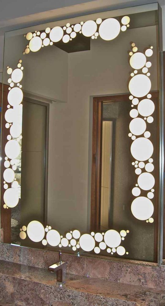 Backlit art glass mirror with etched bubble border above bathroom vanity