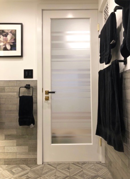 Private bathroom door with frosted glass design