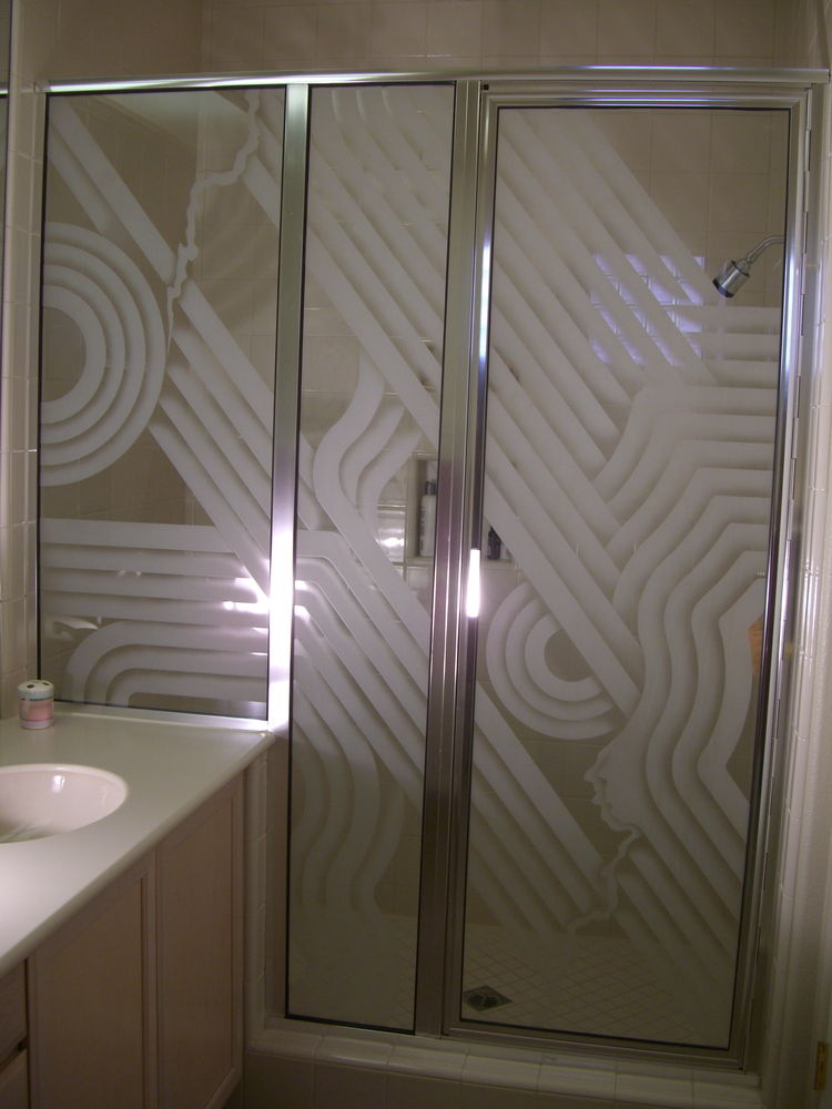 Framed corner shower door with geometric frosted glass pattern creating privacy in a modern bathroom
