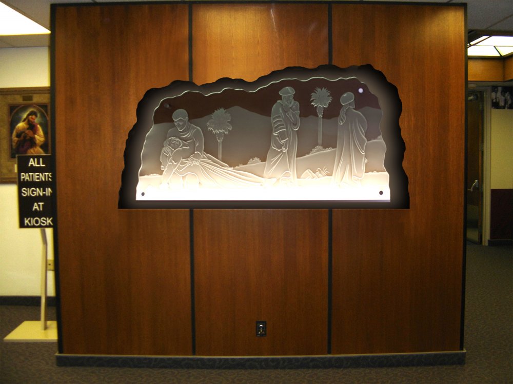 Backlit carved frosted glass wall art with religious scene in building interior