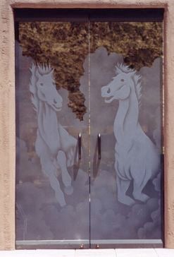Handcrafted Etched Glass Frameless Glass Door Entry by Sans Soucie Art Glass with Custom Western Design Called Stallions Creating Semi-Private