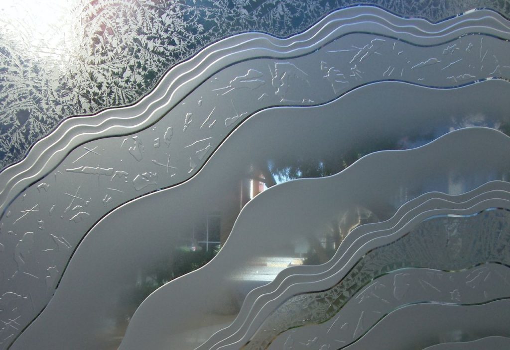 Close-up of Metacurl design on 3D carved and shaded frosted glass with gluechip texture and semi-privacy.