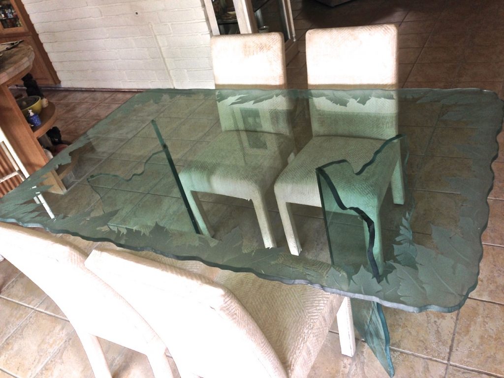 carved glass dining table top featuring Banana Leaves Edge design by Sans Soucie Art Glass.