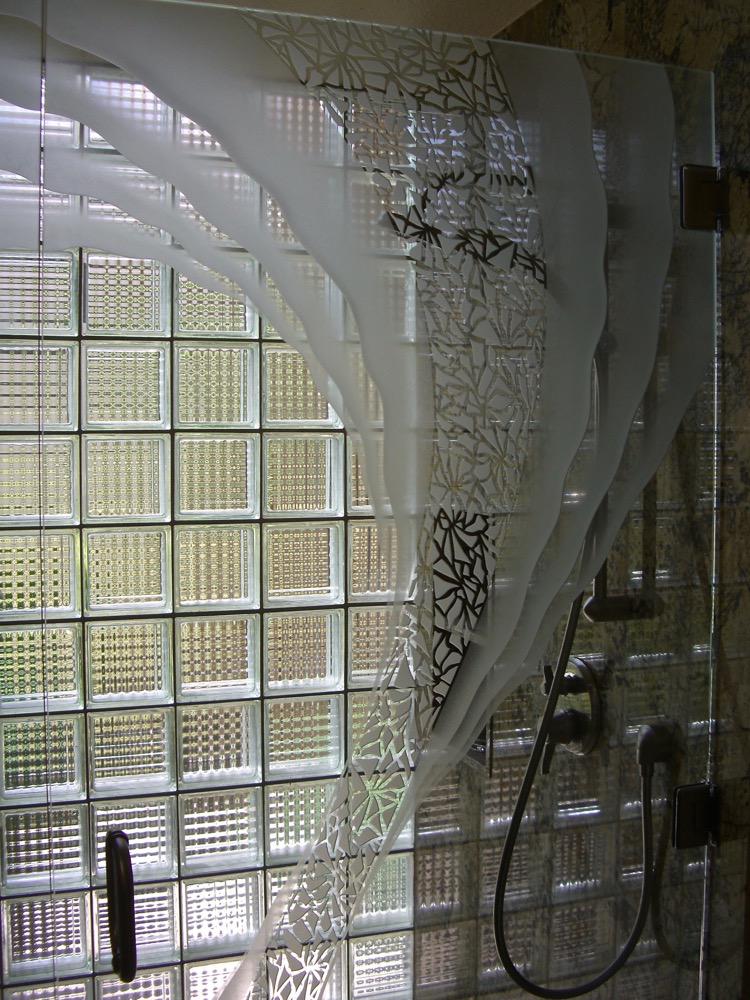 Close-up look of frosted glass shower door with stunning carved details