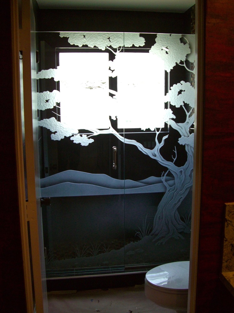 Shower enclosure with decorative frosted bonsai tree landscape design sandblasted into glass for privacy
