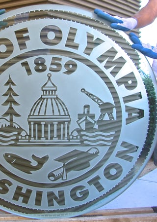 Glass Sign featuring a Frosted Glass Logos Design Sandblast Etched Glass City of Olympia (similar look) Design by Sans Soucie