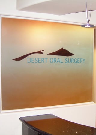 Partition showcasing a Frosted Glass Logos Design with Sandblast Etched Glass Art by Sans Soucie Desert Oral Surgery (similar look) Design
