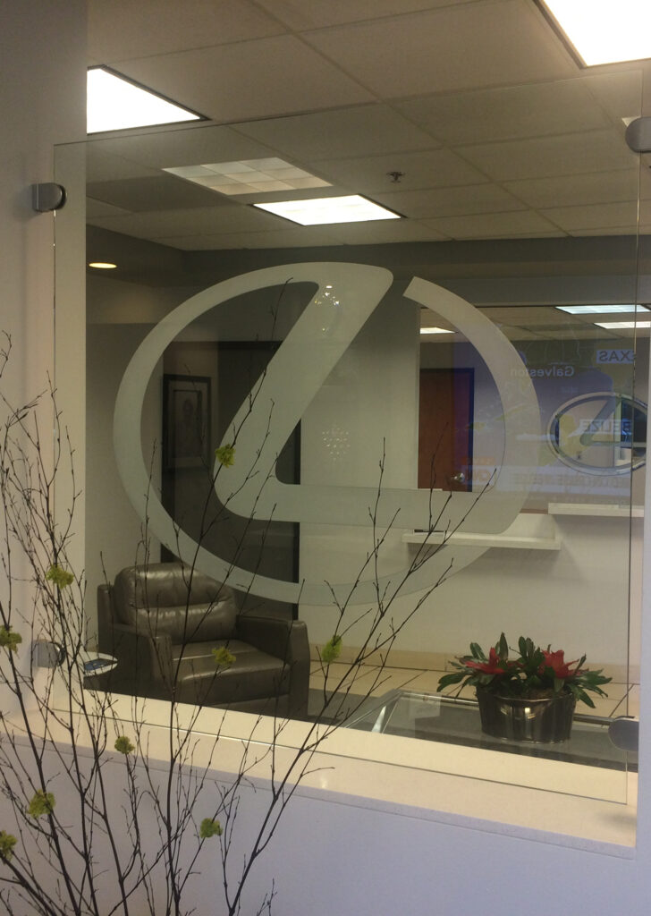 Glass partition wall with etched Lexus logo used as interior glass feature