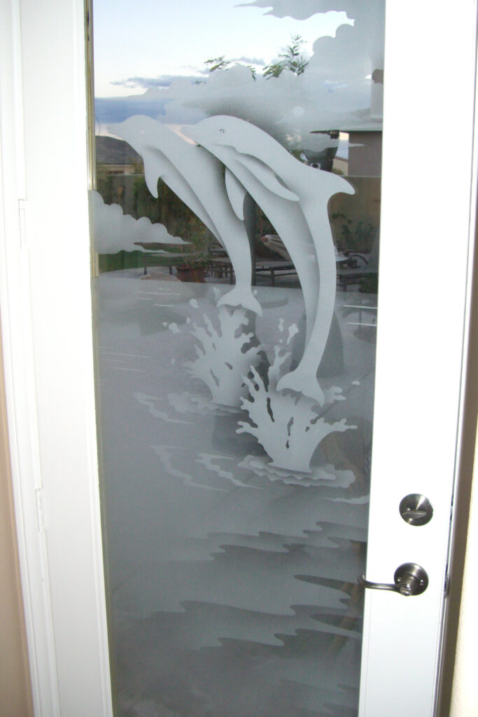 Frosted glass door with sandblasted dolphins leaping from ocean waves, decorative etched glass panel in a white door