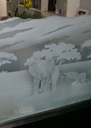 Partition showcasing a Frosted Glass Wildlife Design with Sandblast Etched Glass Art by Sans Soucie Elephants in the Wild Design