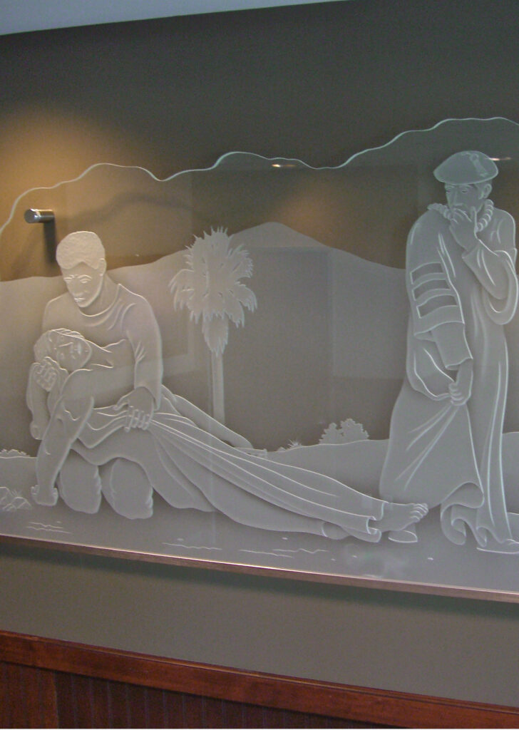 Interior decorative glass partition wall depicting a carved figurative scene in frosted and etched glass
