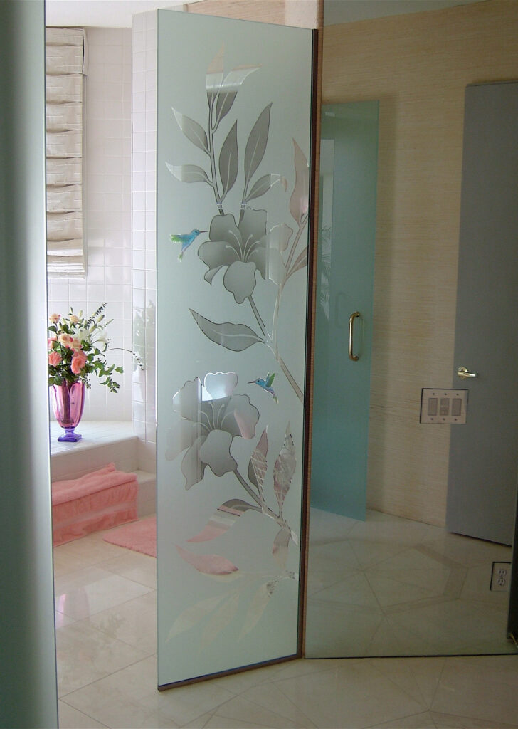 Decorative art glass shower partition with hibiscus flowers and hummingbirds etched into frosted glass