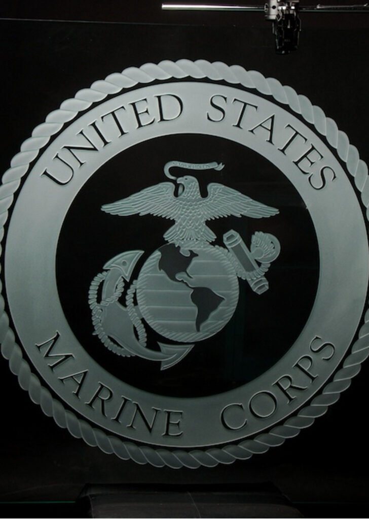 3D carved and illuminated glass sign of United States Marine Corps seal with edge lighting, creating a dramatic and permanent custom display