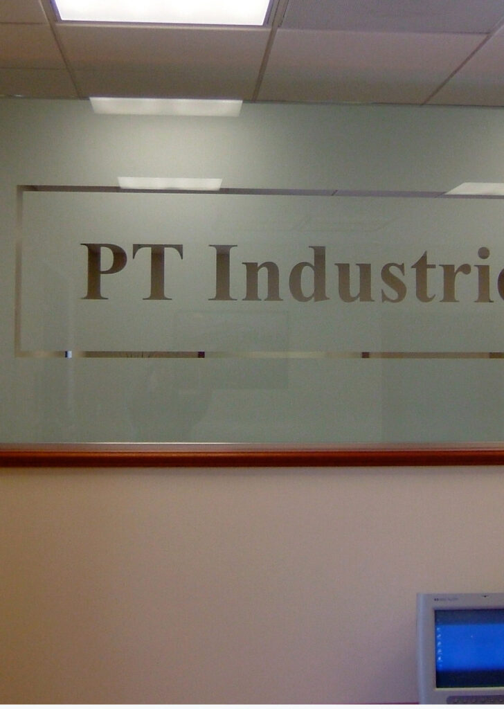 Office glass partition with frosted glass company logo providing privacy and branding