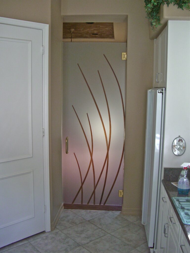 Frameless interior glass pantry door with etched vertical reed design, offering a clean decorative upgrade in a bright kitchen space
