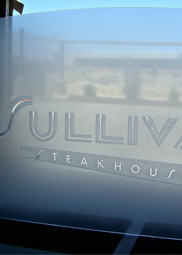 Edge Lit Glass with Frosted Glass Logos Sullivans Steakhouse (similar look) Design by Sans Soucie